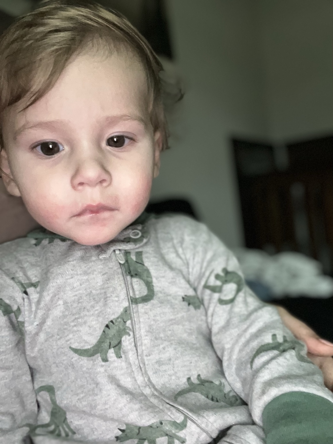 Charlie wearing gray dinosaur pajamas